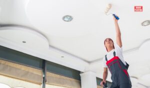 A Man Painting A Ceiling