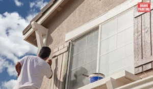 A Man Painting A Window
