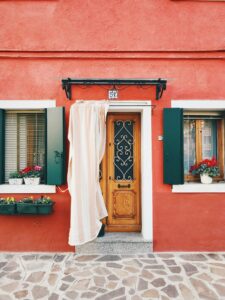 A Red House With A Door And Windows