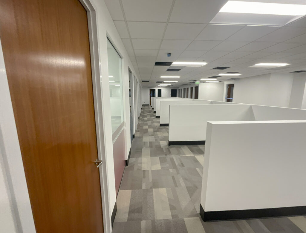 a room with cubicles and a door