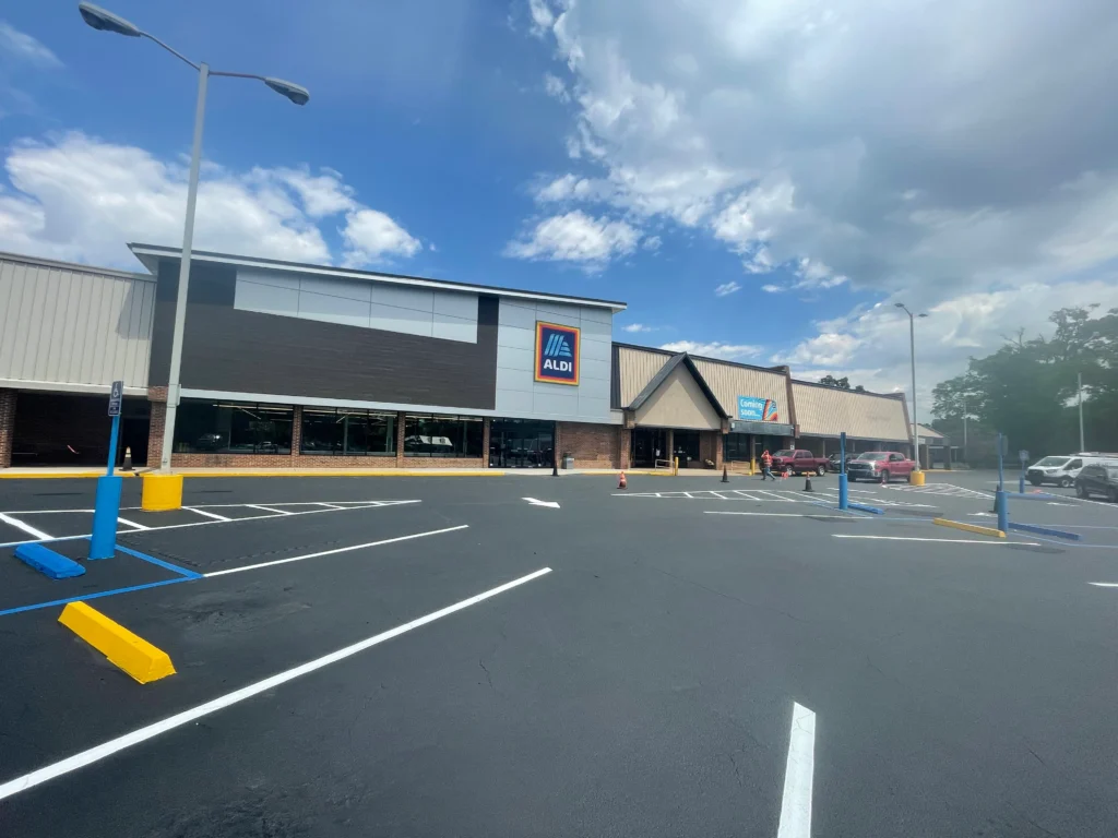 a parking lot with a building and a parking lot