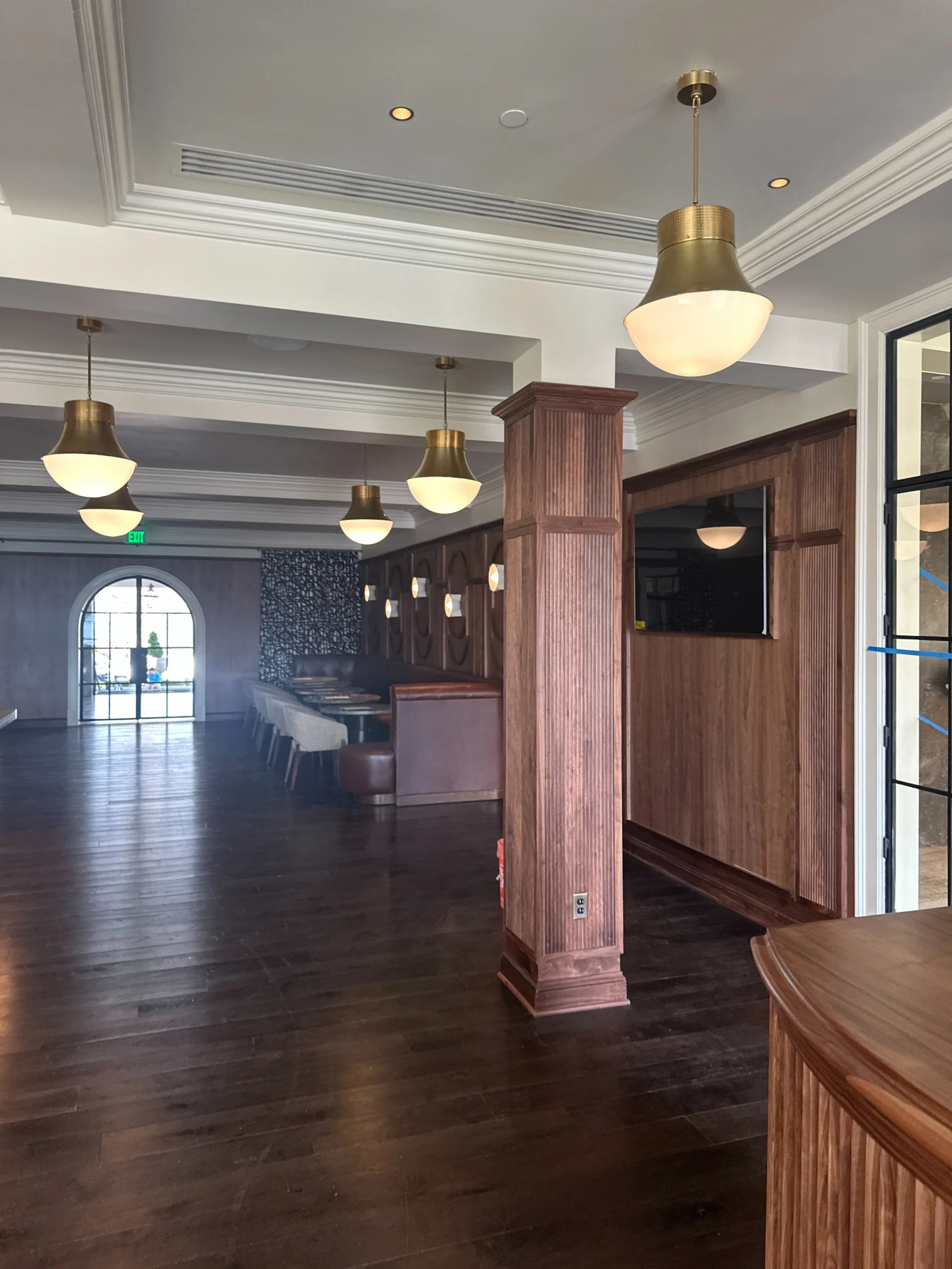 a room with a wood floor and a large window