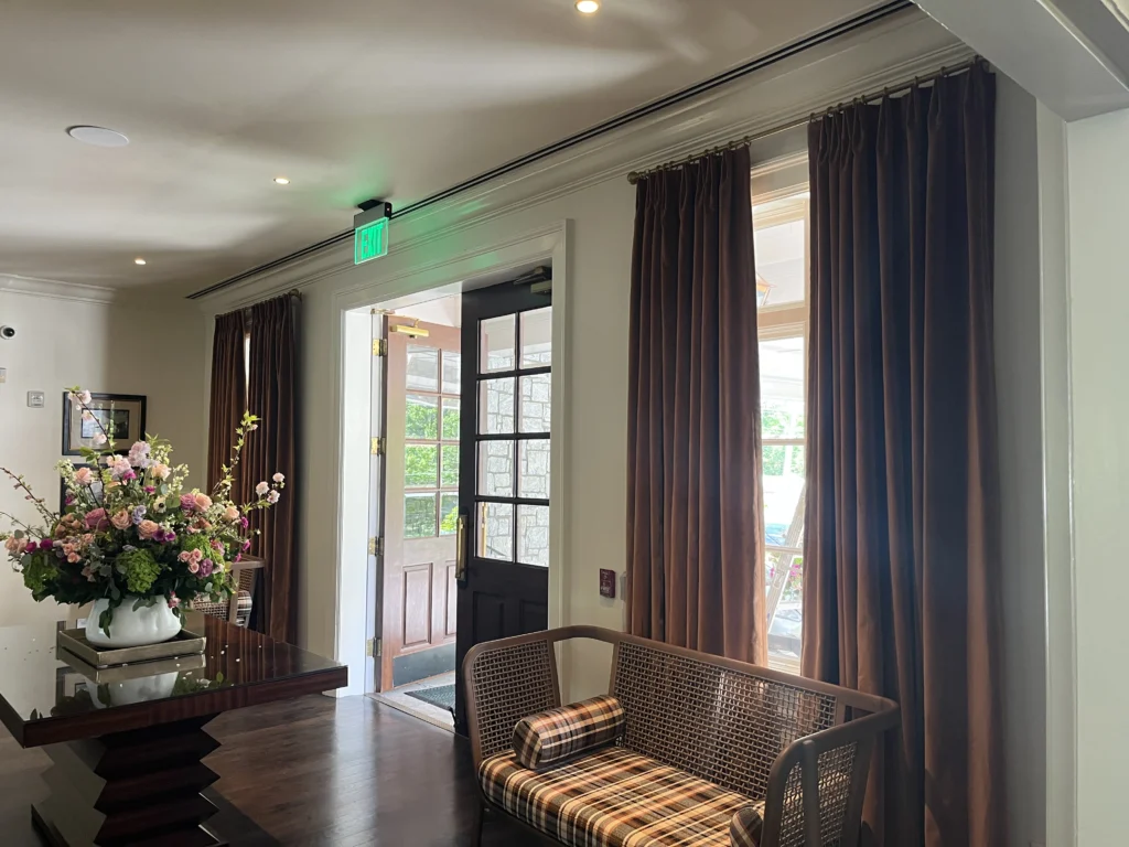 a room with a couch and a table with flowers