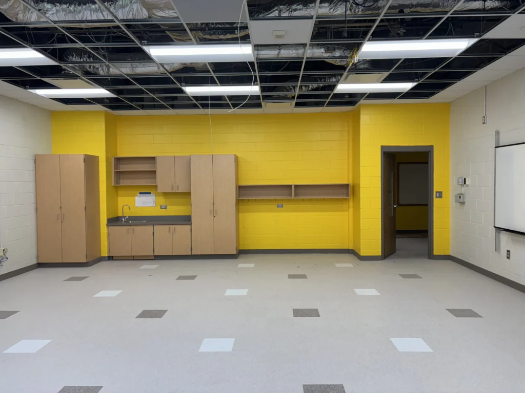 a room with yellow walls and cabinets
