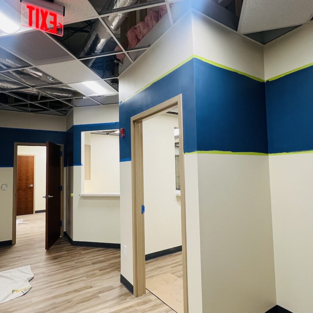 a room with blue and white walls and a wood floor