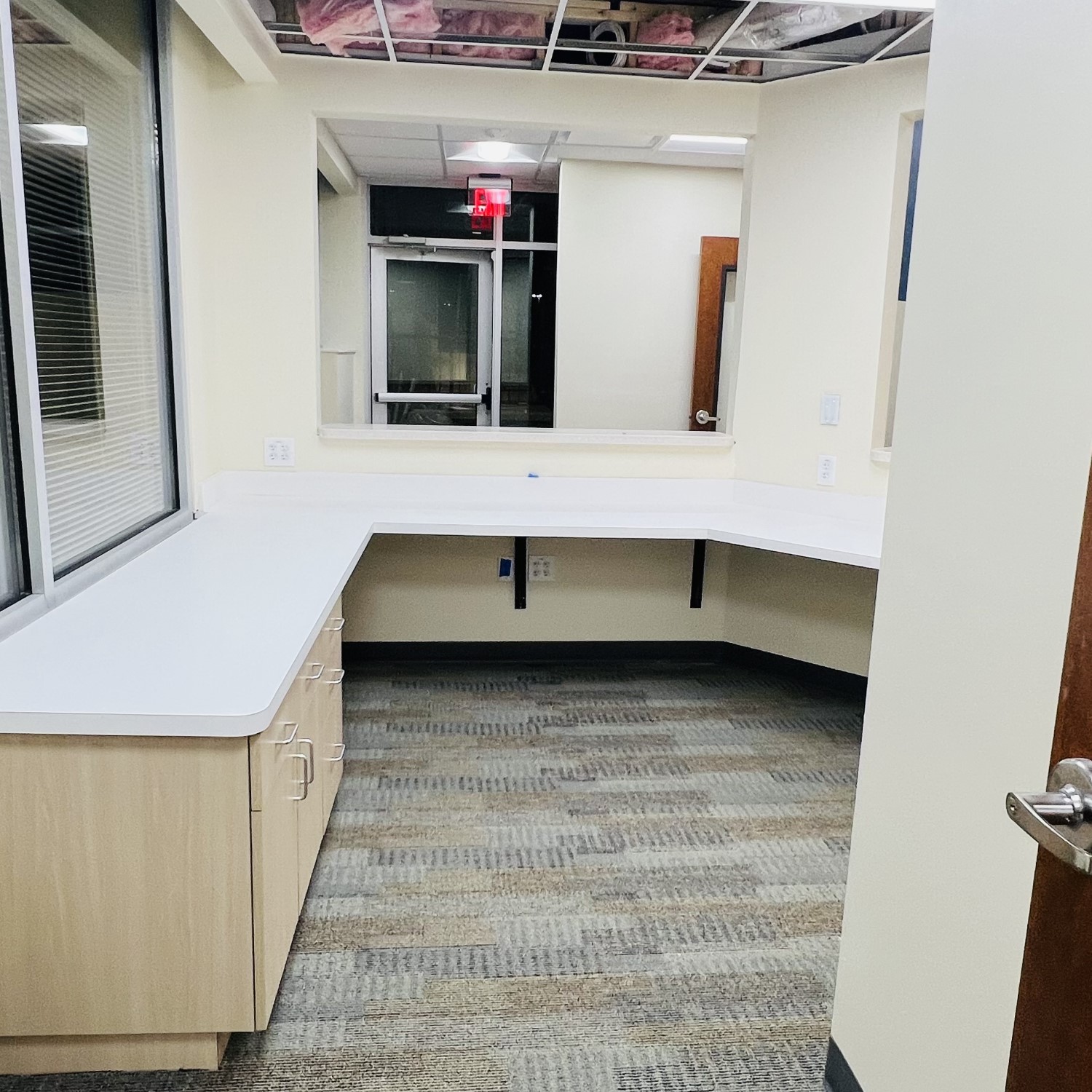 a room with a window and a white countertop