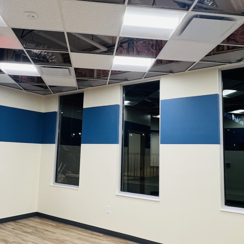 a room with blue and white walls and windows
