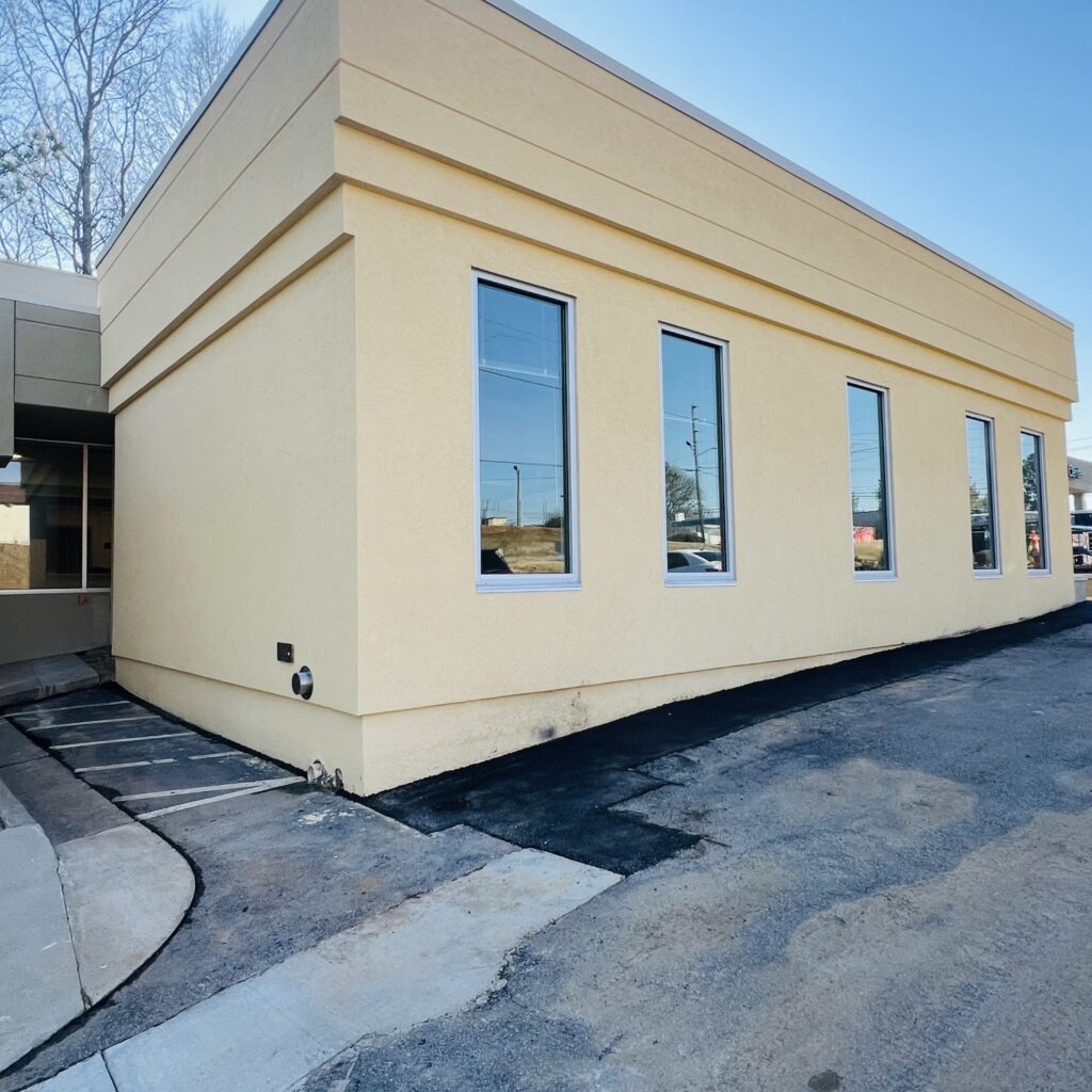 a building with windows and a driveway