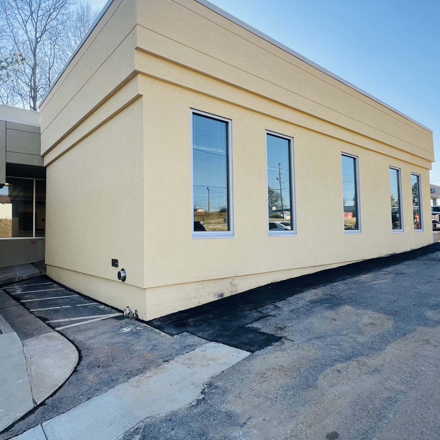 a building with windows and a driveway