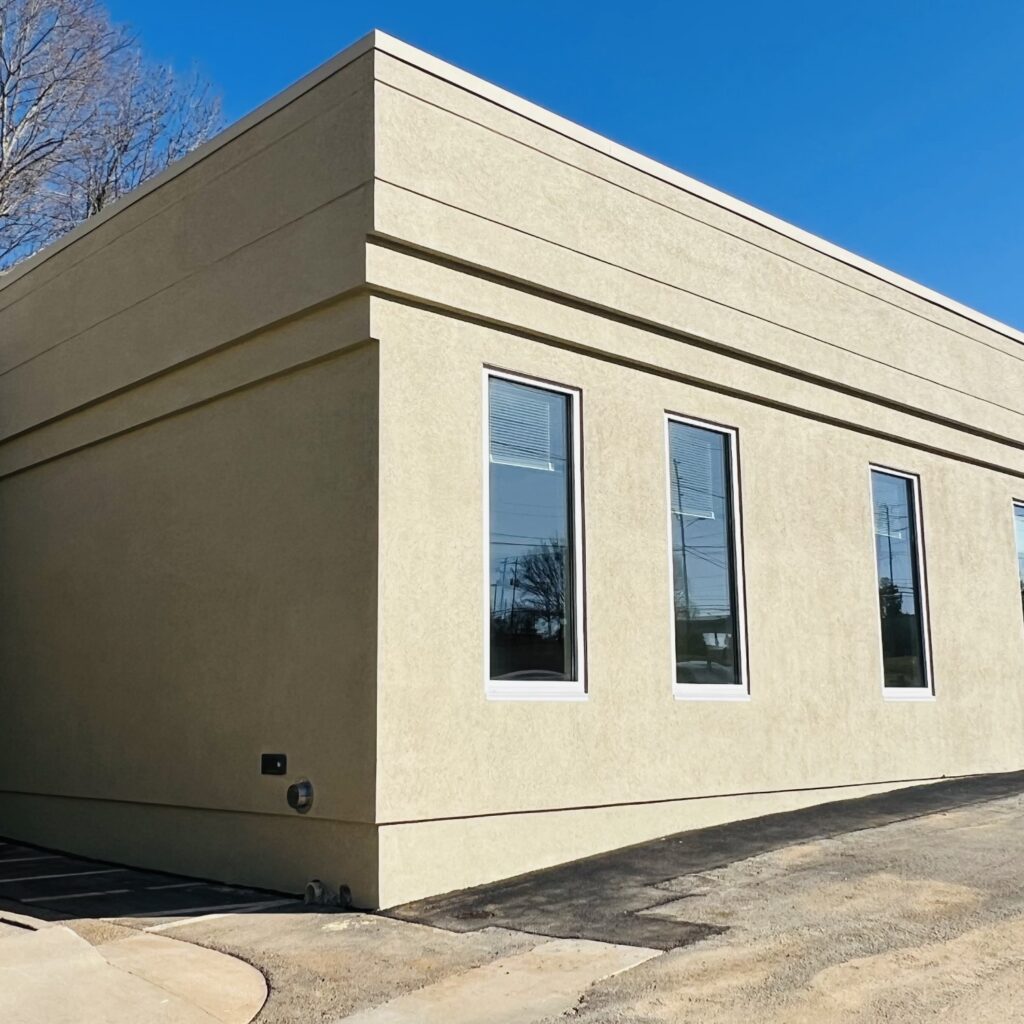 a building with windows and a parking lot