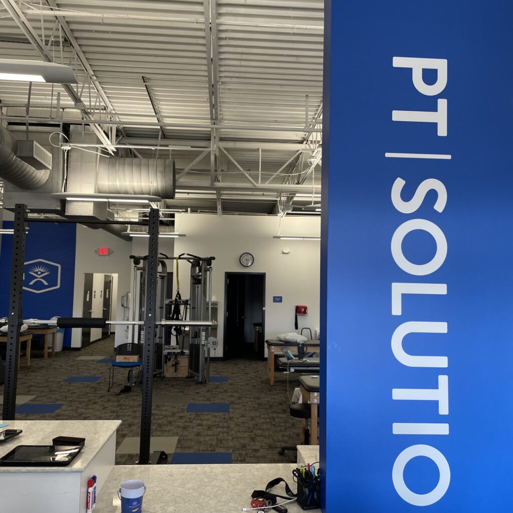 a blue and white sign in a gym