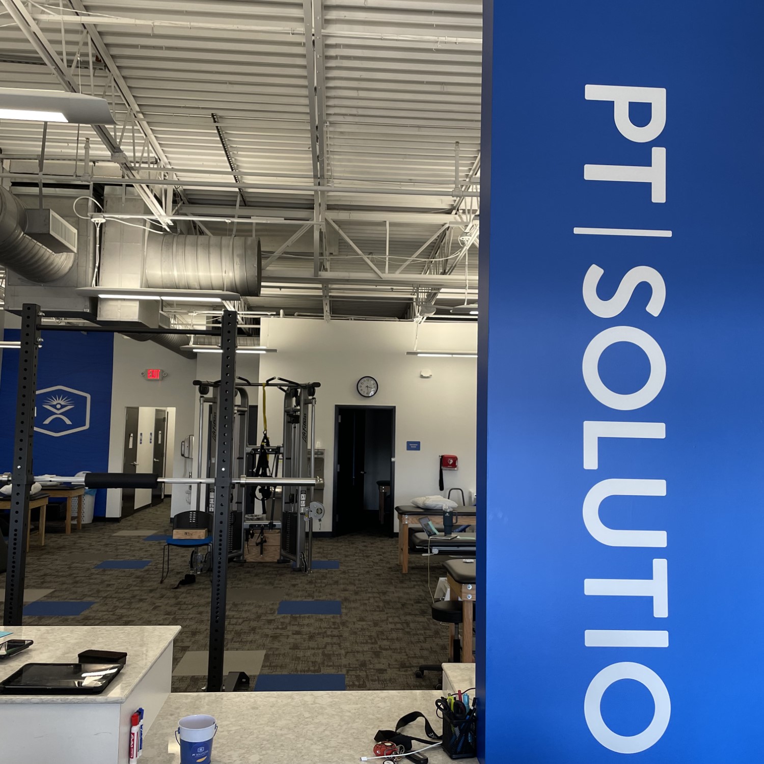 a blue and white sign in a gym