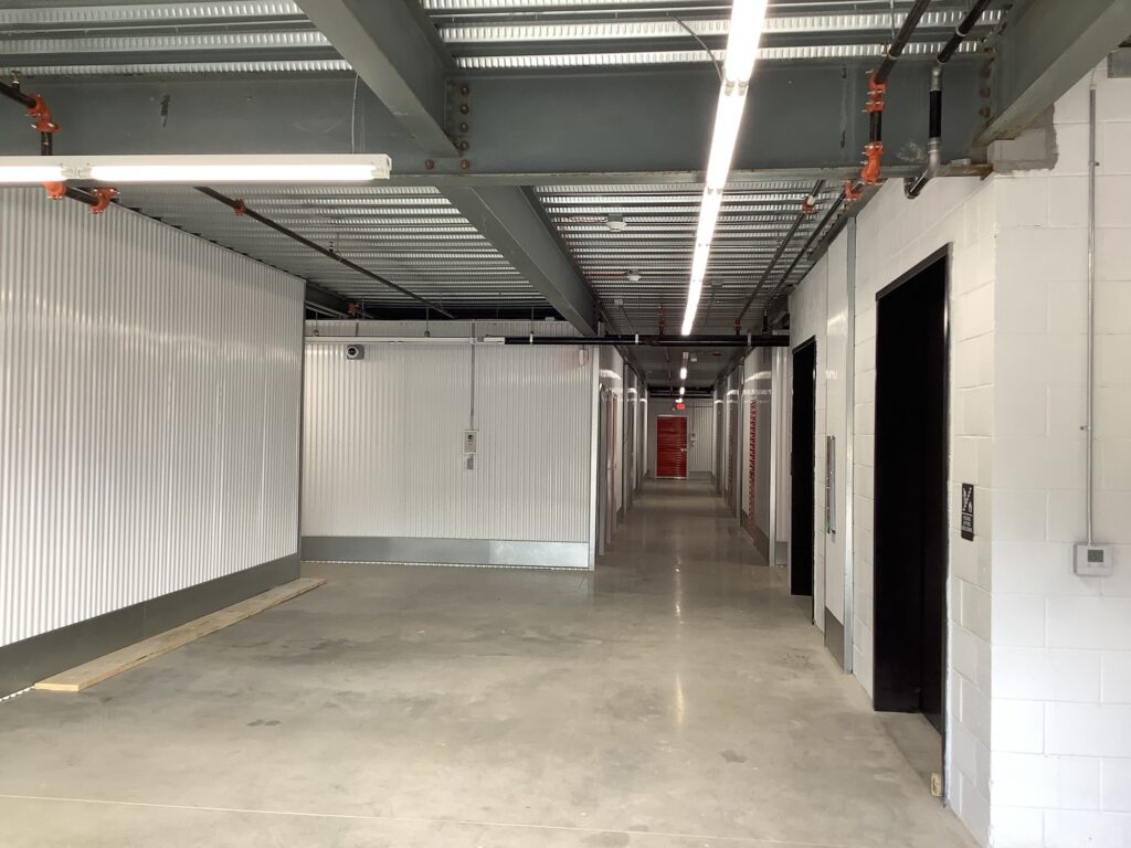 a hallway with white walls and metal walls