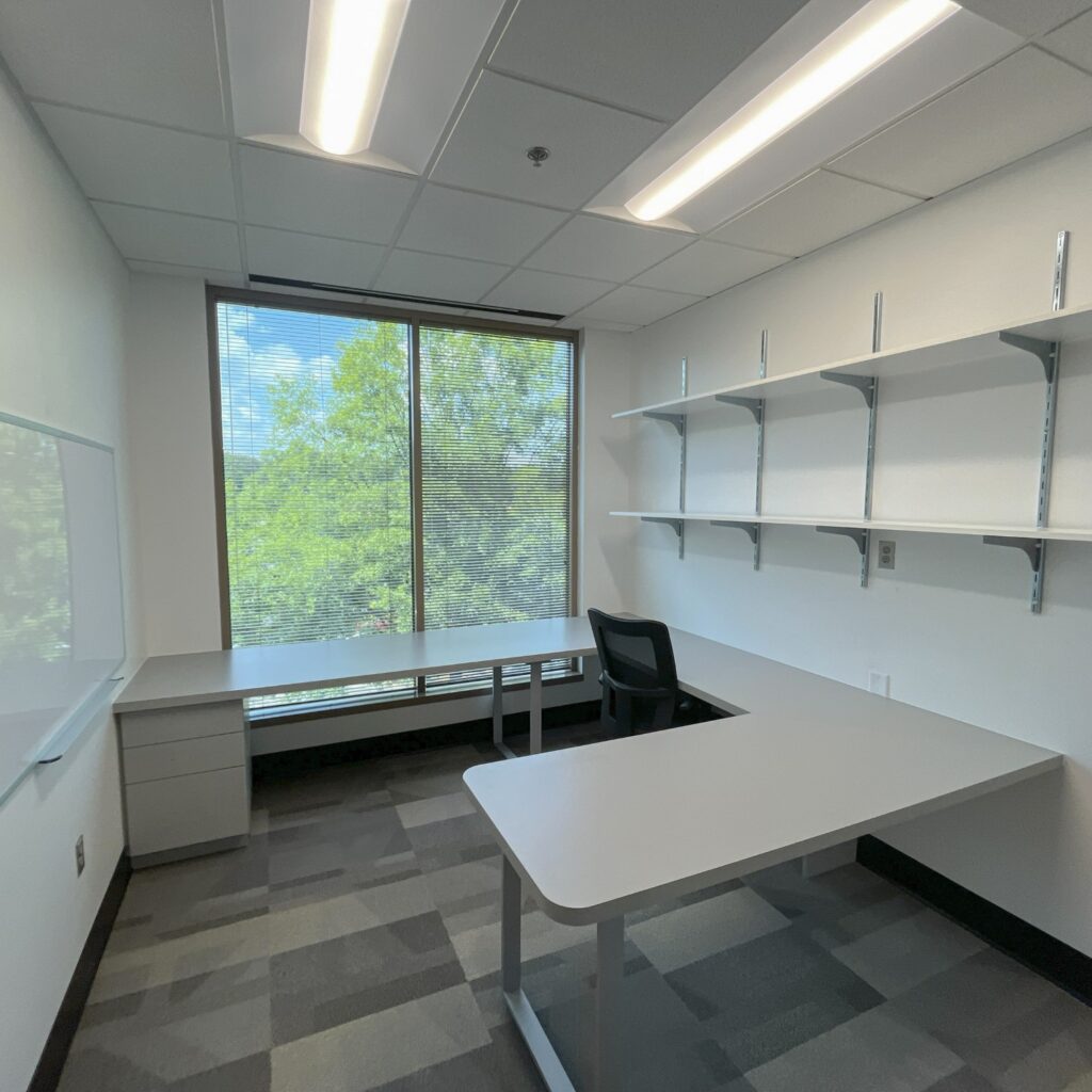 a room with a white board and shelves