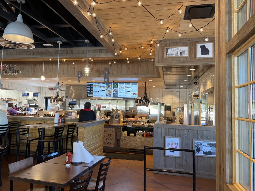 a restaurant with lights from the ceiling