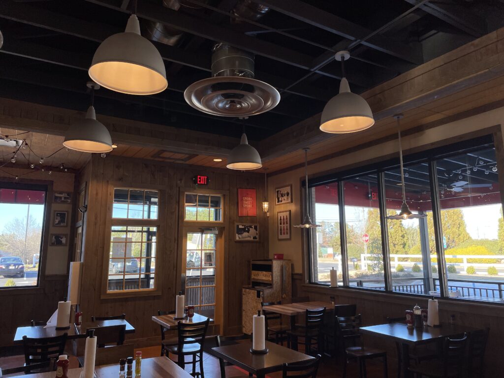 a room with tables and chairs and a window