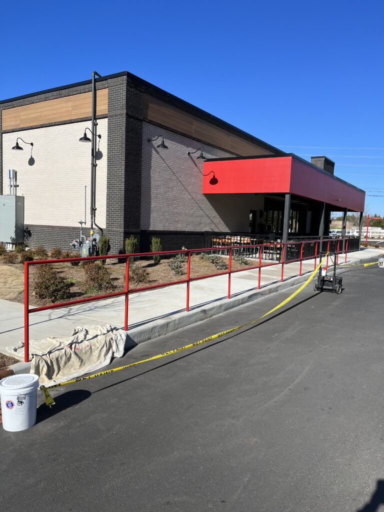 a building with red railings and a red railing
